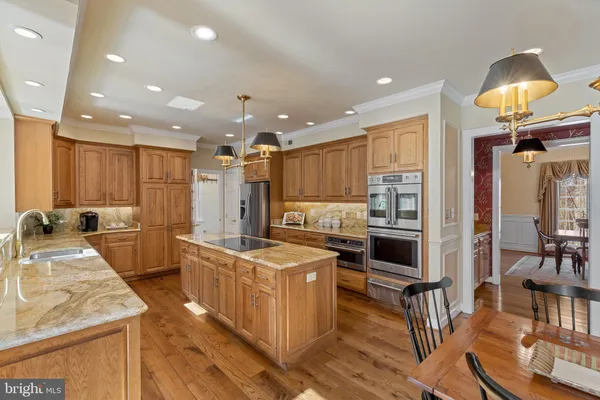 a kitchen with a table chairs refrigerator and cabinets