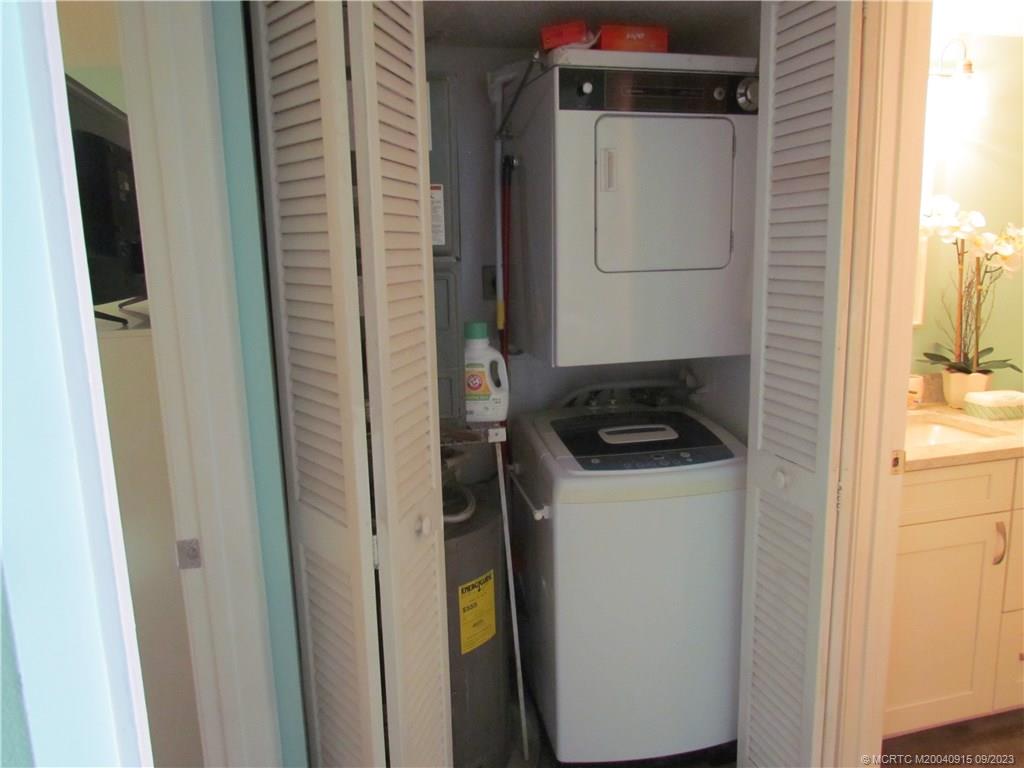 9400 South Ocean Drive, Unit 504B Jensen Beach, FL 34957 - Photo 14 of 42 a utility room with a refrigerator and washer