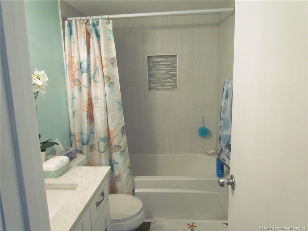 9400 South Ocean Drive, Unit 504B Jensen Beach, FL 34957 - Photo 15 of 42 a bathroom with a sink a toilet and shower