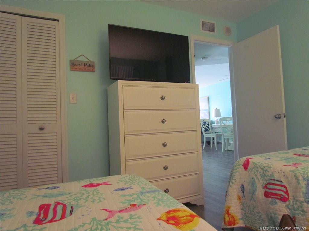 9400 South Ocean Drive, Unit 504B Jensen Beach, FL 34957 - Photo 17 of 42 a bedroom with a bed and a flat screen tv