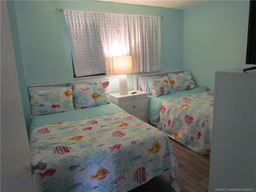 9400 South Ocean Drive, Unit 504B Jensen Beach, FL 34957 - Photo 18 of 42 a bedroom with two beds and a window
