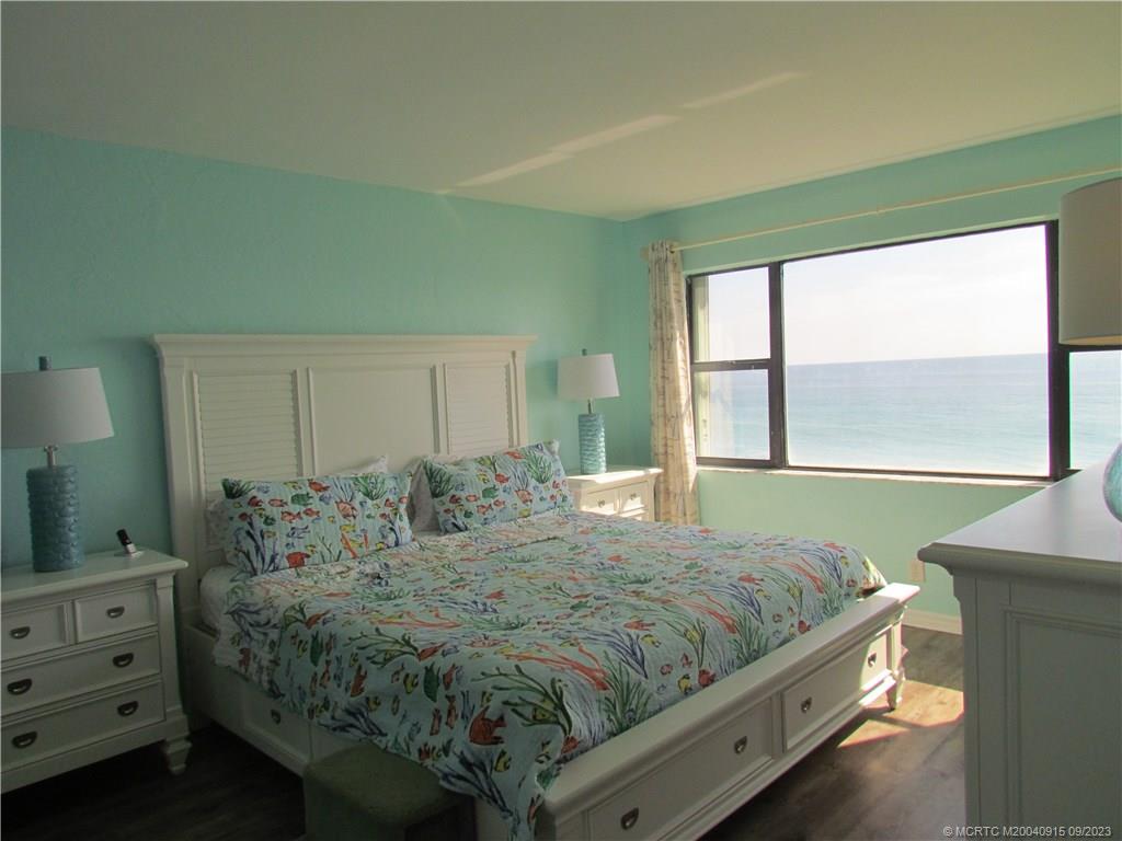 9400 South Ocean Drive, Unit 504B Jensen Beach, FL 34957 - Photo 19 of 42 a bedroom with a bed and large window