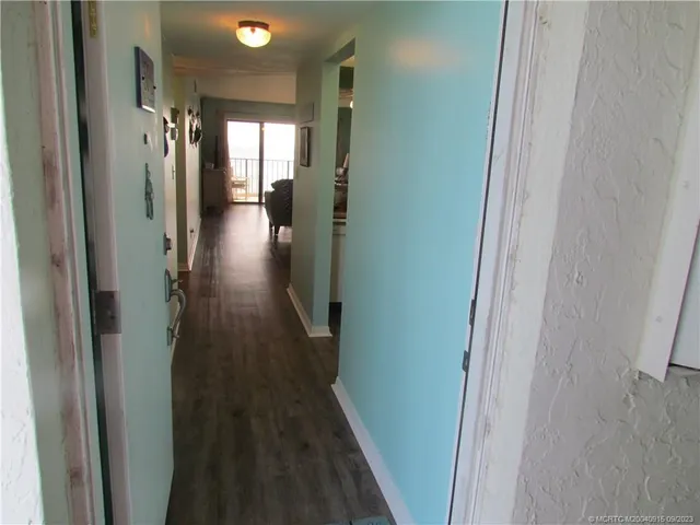 a view of hallway with wooden floor