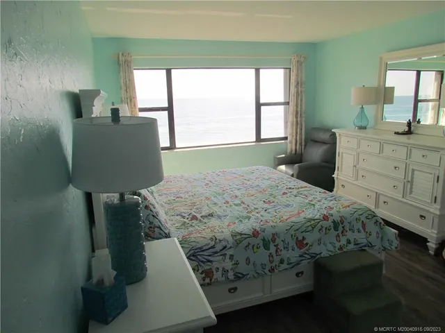 a bedroom with a bed dresser and a window