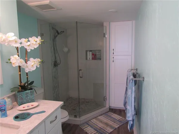 a bathroom with a sink mirror and shower