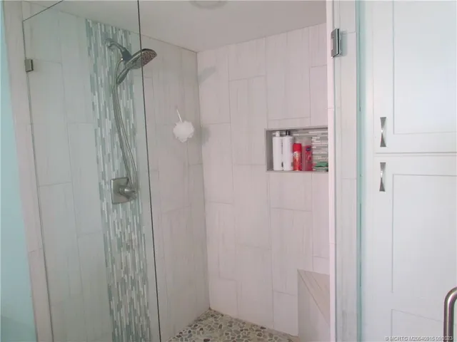 a bathroom with a shower and a sink