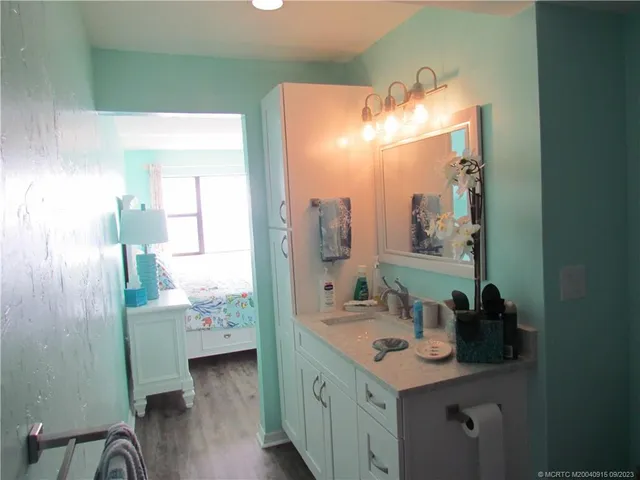 a bathroom with a double vanity sink and a mirror