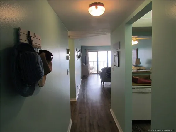 a view of hallway with wooden floor