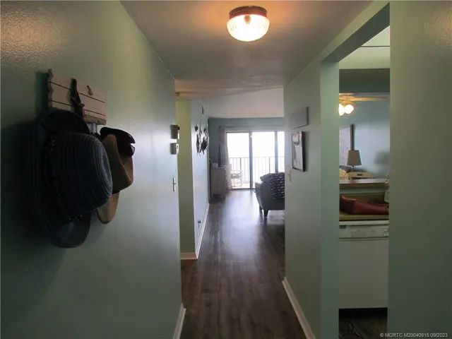 a view of hallway with wooden floor