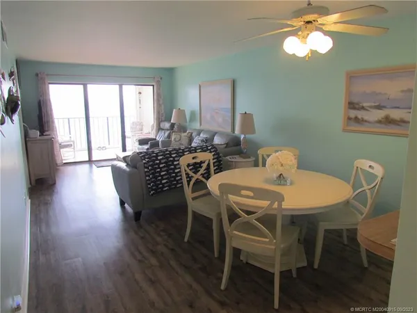 a view of a dining room with furniture window and wooden floor