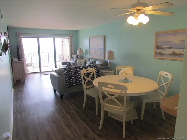 a view of a dining room with furniture window and wooden floor