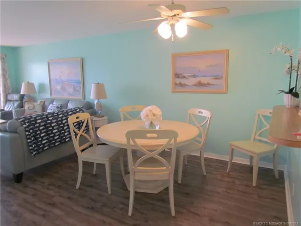 a view of a dining room with furniture and wooden floor