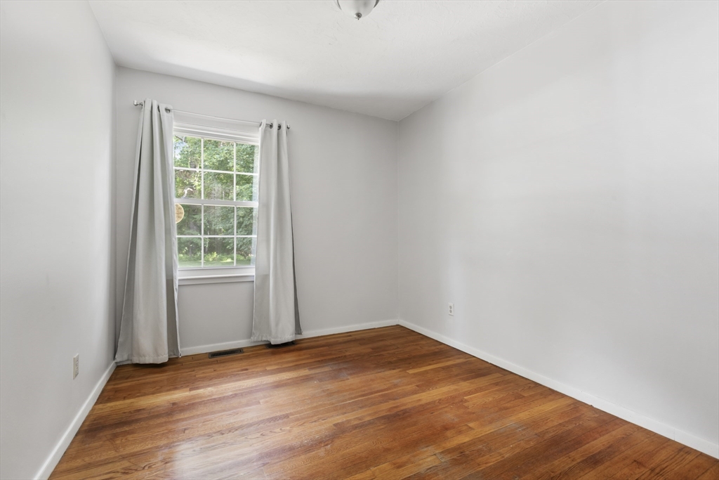 570 Sutton Street Northbridge, MA 01534 - Photo 11 of 20 an empty room with wooden floor and windows