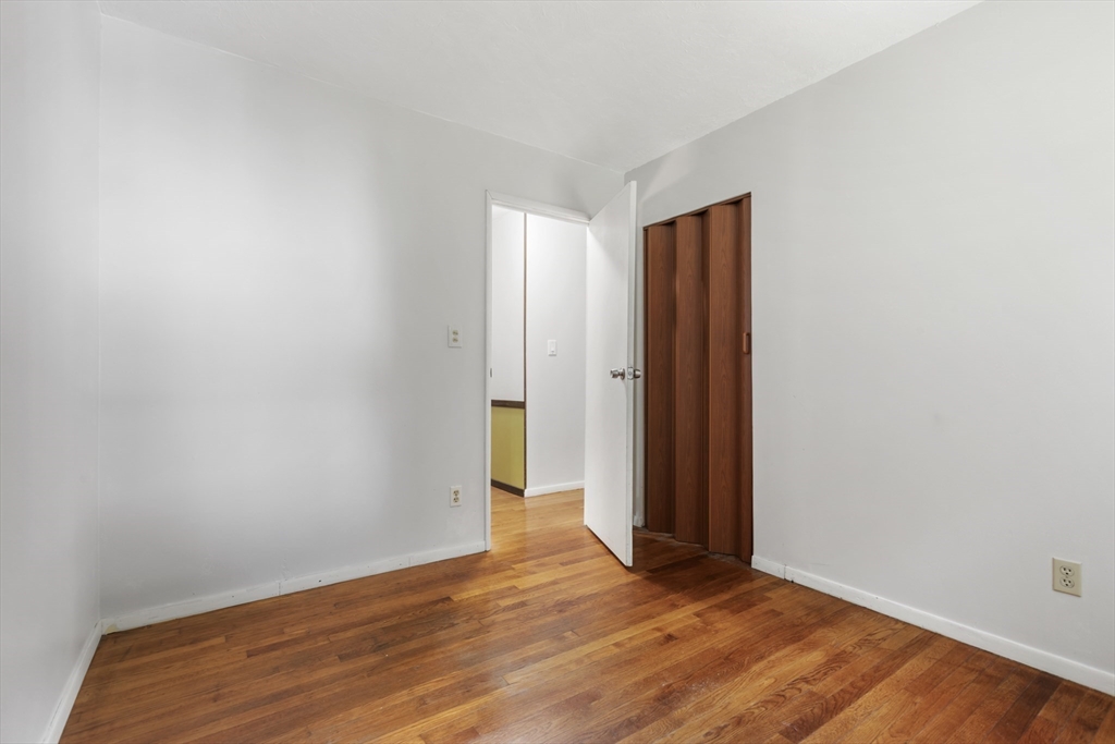 570 Sutton Street Northbridge, MA 01534 - Photo 13 of 20 an empty room with wooden floor and closet