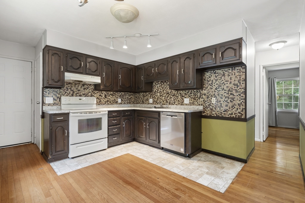 570 Sutton Street Northbridge, MA 01534 - Photo 3 of 20 a kitchen with stainless steel appliances granite countertop a stove and a sink