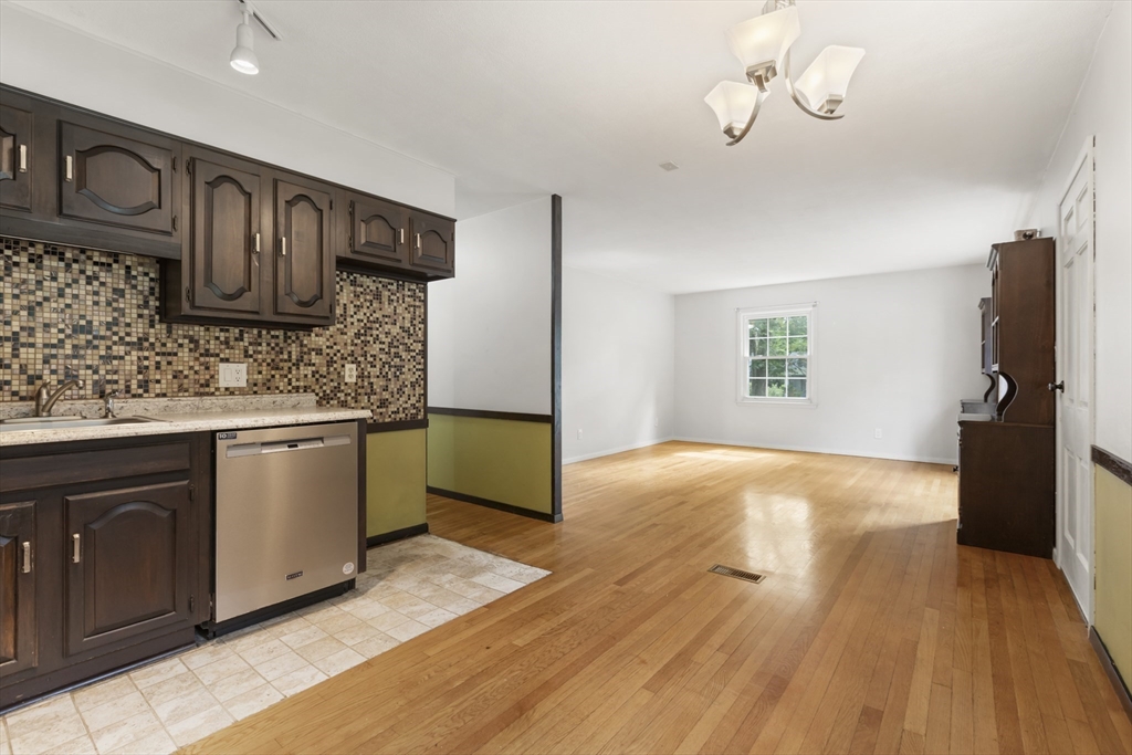 570 Sutton Street Northbridge, MA 01534 - Photo 5 of 20 a kitchen with stainless steel appliances granite countertop a sink dishwasher stove and refrigerator with wooden floor