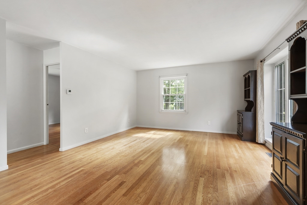 570 Sutton Street Northbridge, MA 01534 - Photo 6 of 20 a view of an empty room with a window and wooden floor