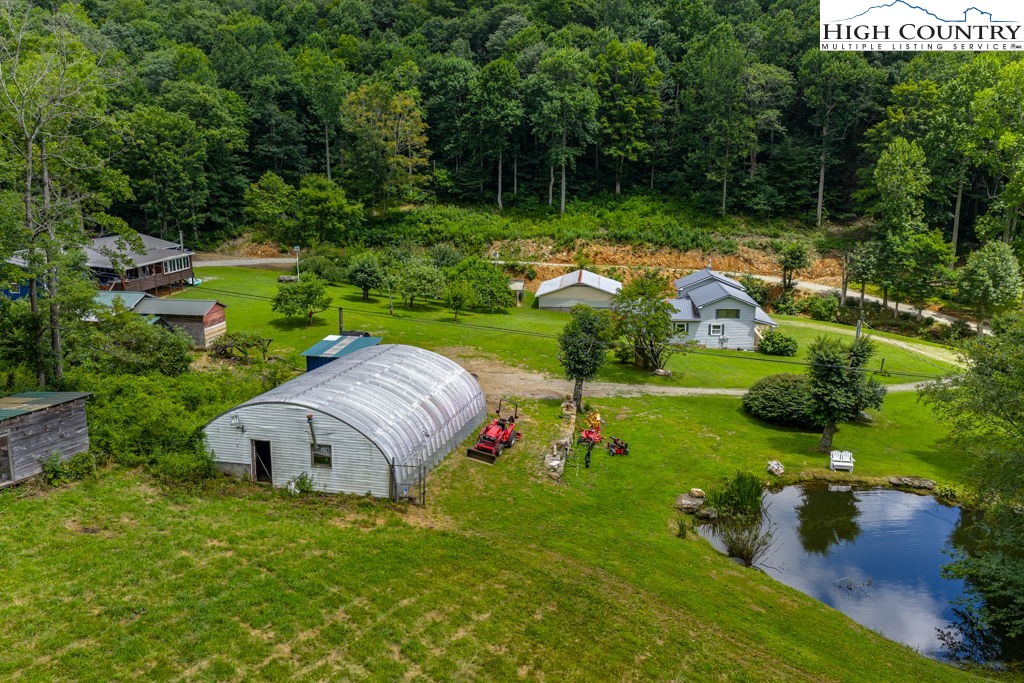 175 Roaring Fork Road Todd, NC 28684 - Photo 23 of 24 a view of a garden with plants and large trees