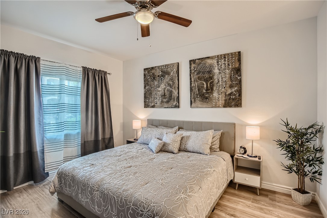 7701 West Robindale Road, Unit 149 Las Vegas, NV 89113 - Photo 10 of 22 Bedroom featuring wood finished floors and a ceiling fan