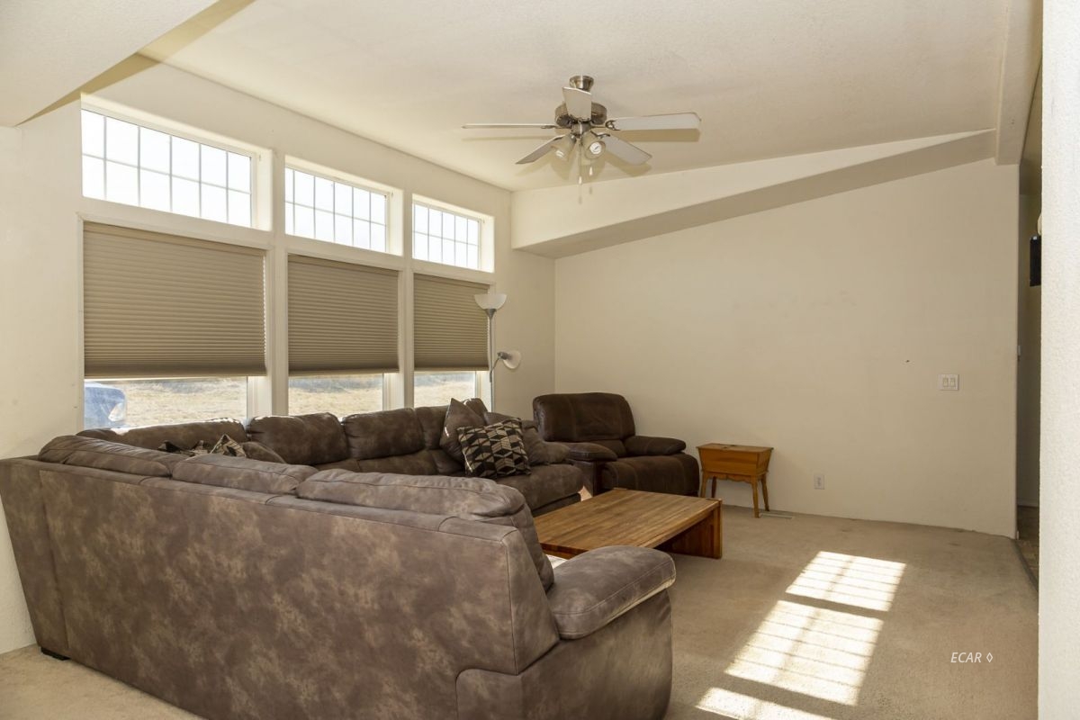 426 Spring Valley Parkway Spring Creek, NV 89815 - Photo 3 of 16 a living room with furniture and window
