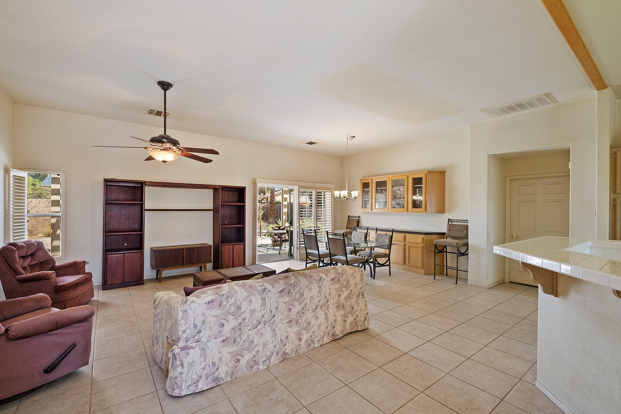 68338 Riviera Road Cathedral City, CA 92234 - Photo 11 of 29 a living room with furniture a dining table and chairs