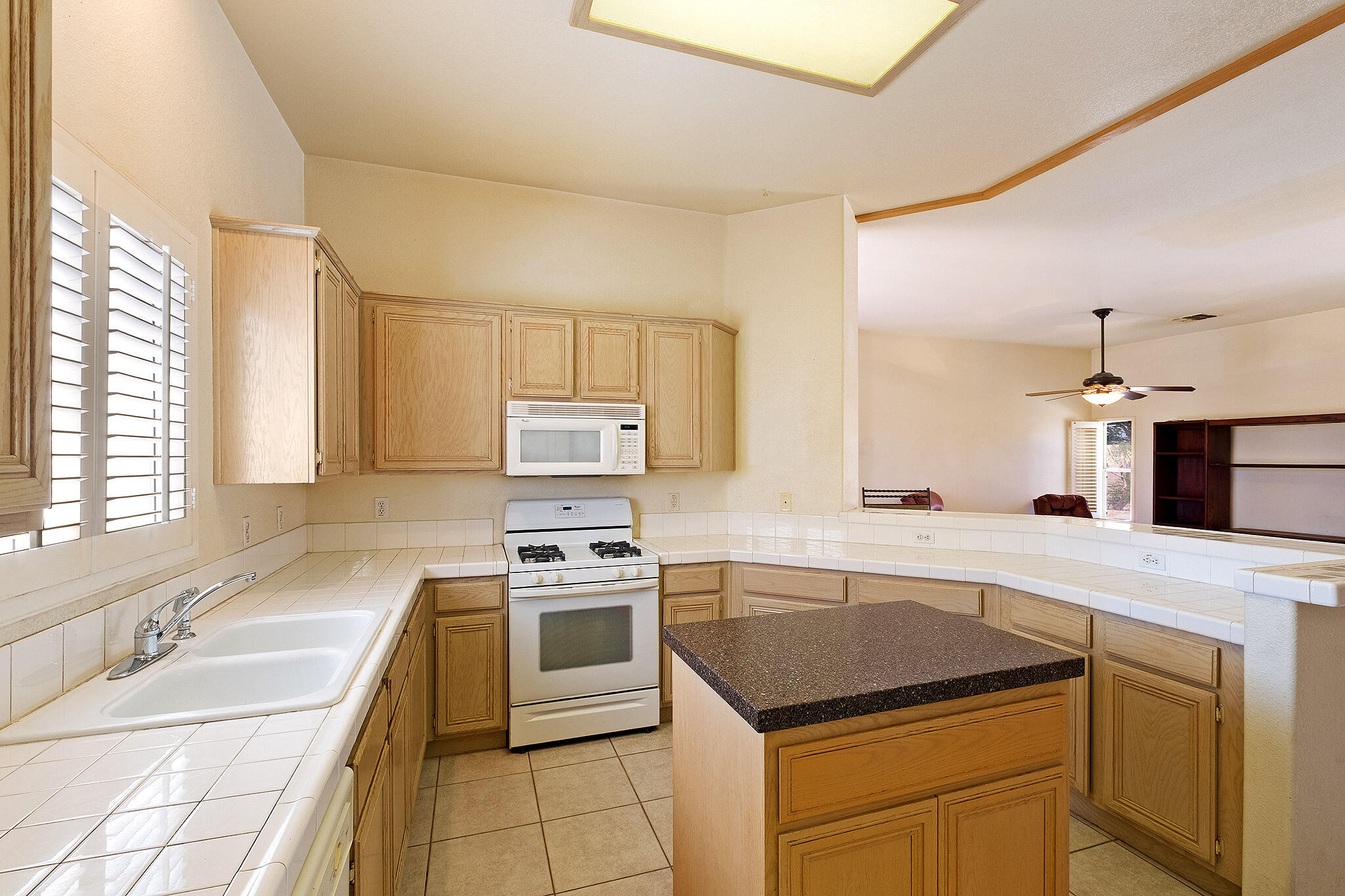 68338 Riviera Road Cathedral City, CA 92234 - Photo 15 of 29 a kitchen with stainless steel appliances granite countertop a sink stove and refrigerator