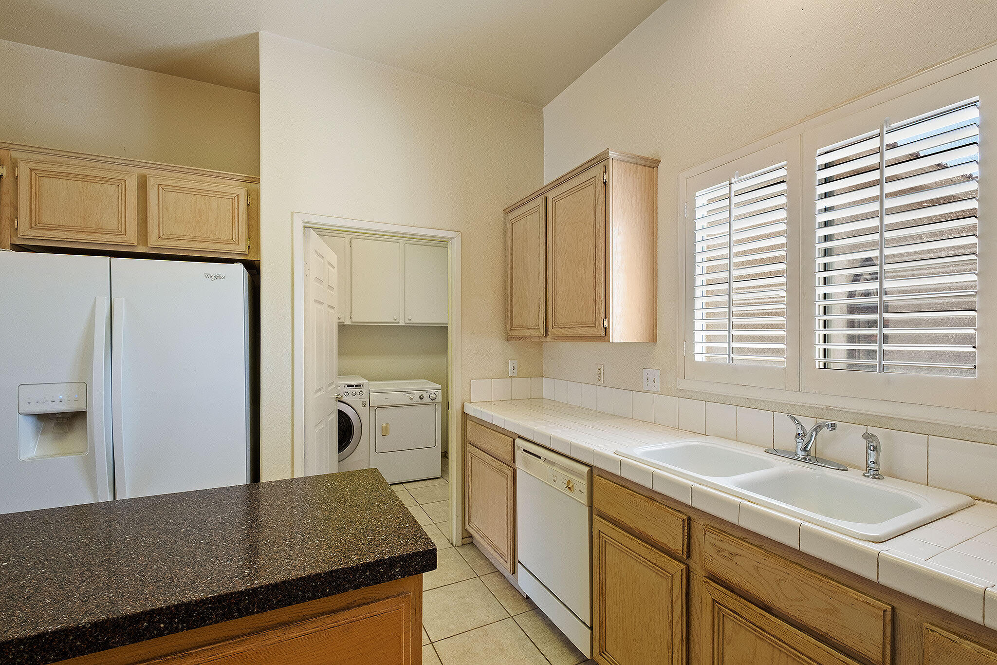 68338 Riviera Road Cathedral City, CA 92234 - Photo 17 of 29 a kitchen with a sink stove and refrigerator