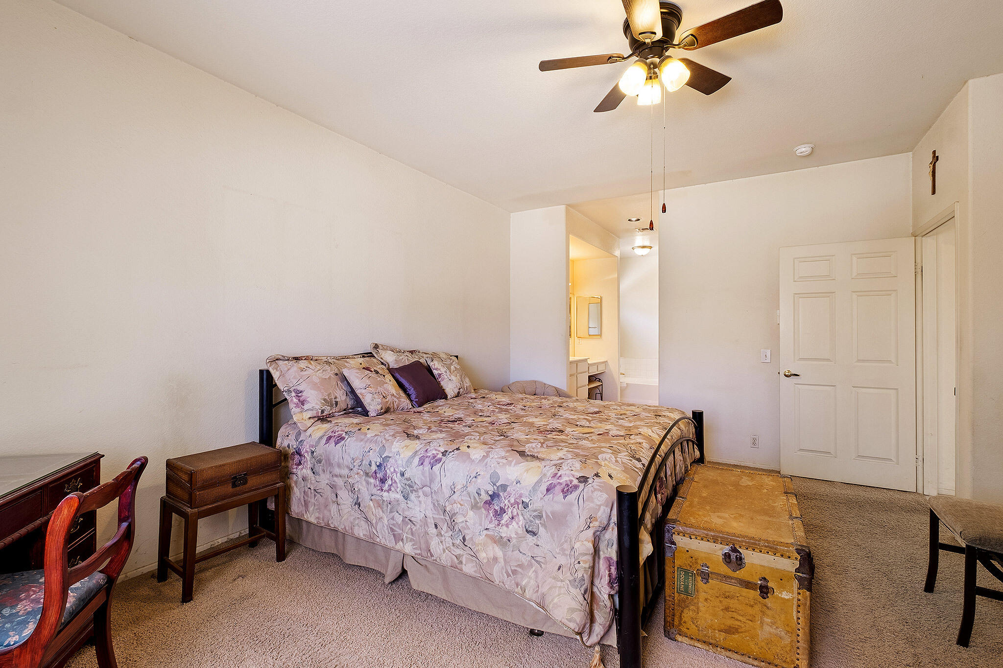 68338 Riviera Road Cathedral City, CA 92234 - Photo 19 of 29 a bedroom with a bed and a chandelier