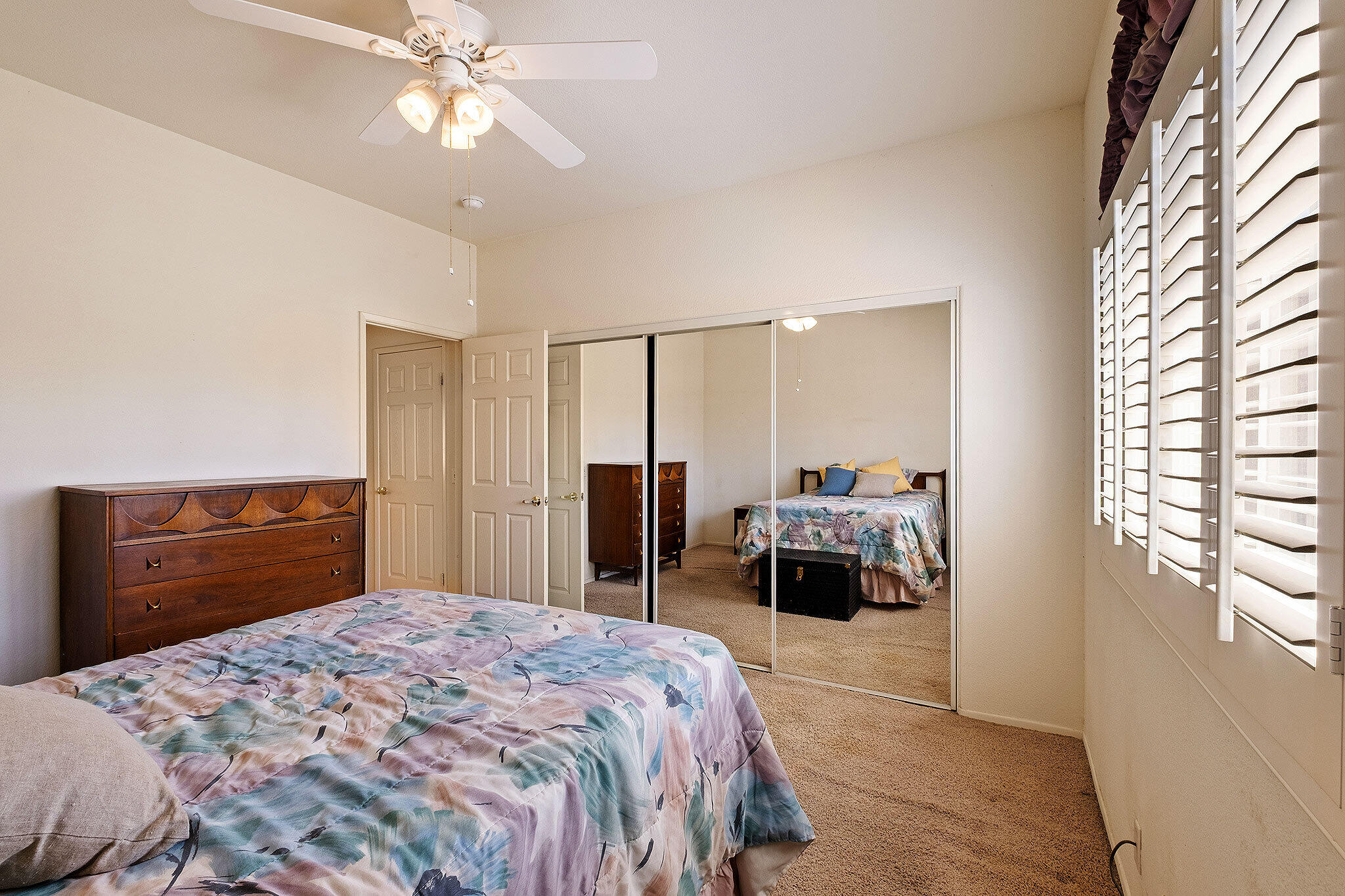 68338 Riviera Road Cathedral City, CA 92234 - Photo 26 of 29 a bedroom with a bed and a chandelier