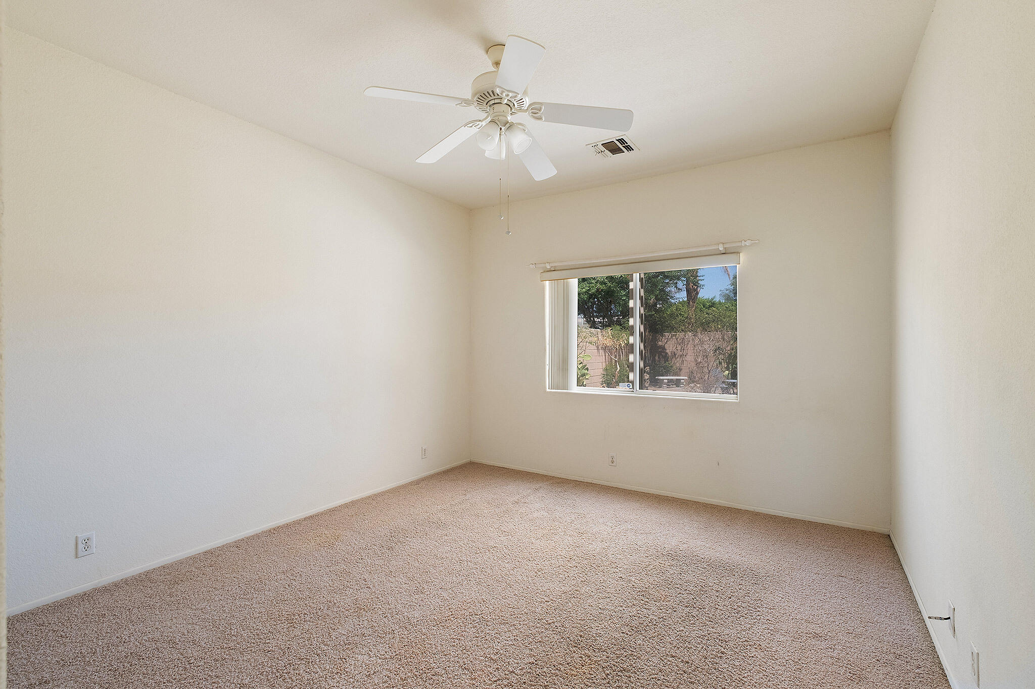 68338 Riviera Road Cathedral City, CA 92234 - Photo 29 of 29 an empty room with a window and a fan