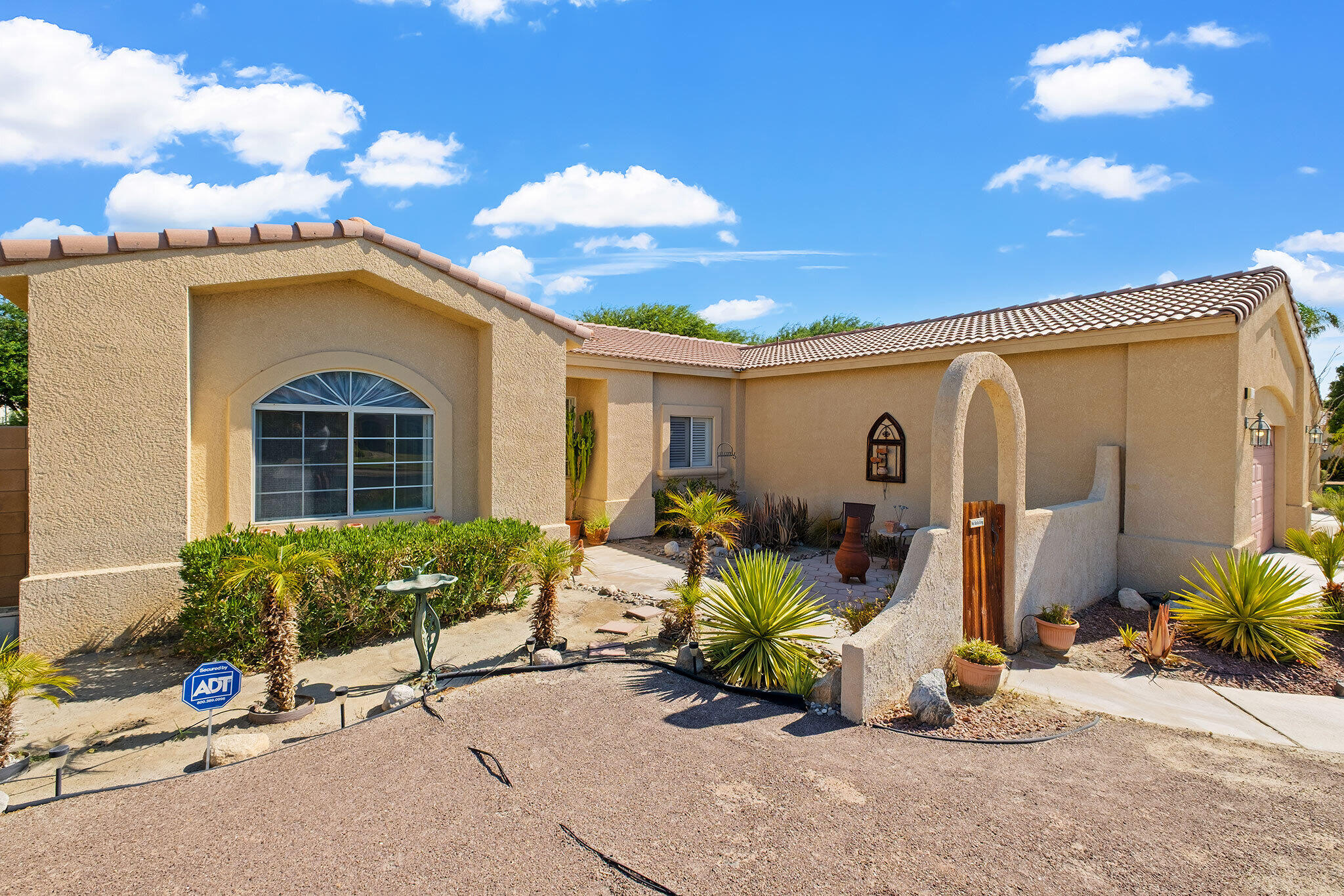 68338 Riviera Road Cathedral City, CA 92234 - Photo 3 of 29 a view of a house with furniture and potted plants