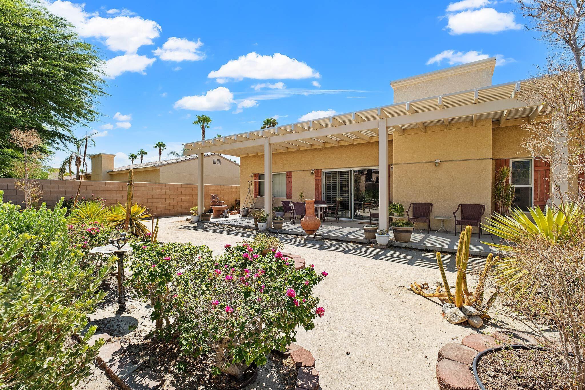 68338 Riviera Road Cathedral City, CA 92234 - Photo 10 of 29 a view of a patio with table and chairs and potted plants