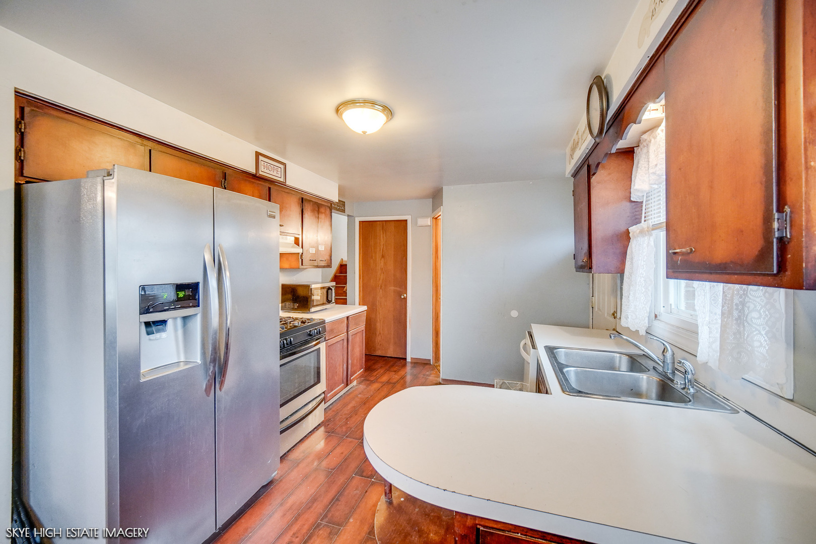 14850 Homan Avenue Midlothian, IL 60445 - Photo 2 of 13 a kitchen with stainless steel appliances a refrigerator and a stove