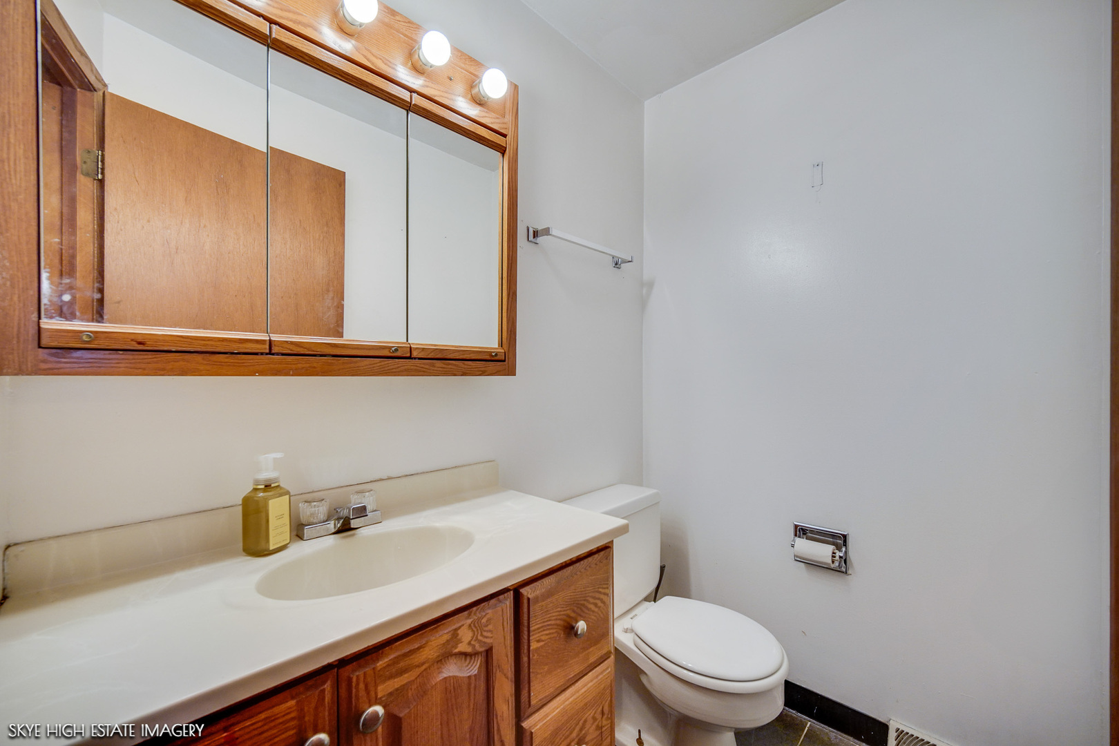 14850 Homan Avenue Midlothian, IL 60445 - Photo 5 of 13 a bathroom with a sink a toilet and mirror