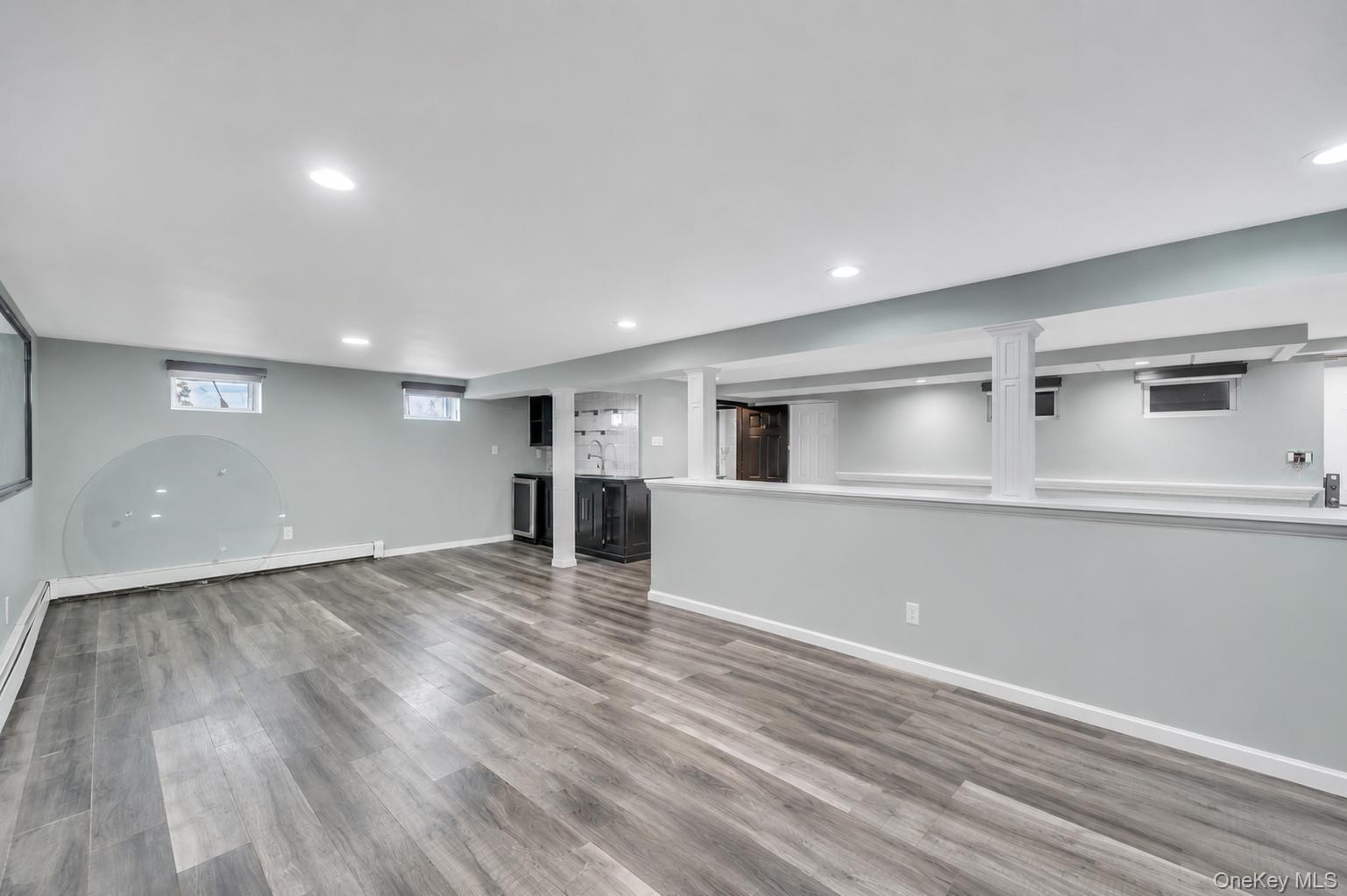 19 Joan Road Bay Shore, NY 11706 - Photo 41 of 50 Spacious lower level featuring wood-finish flooring, recessed lighting, and a built-in wet bar with a beverage refrigerator