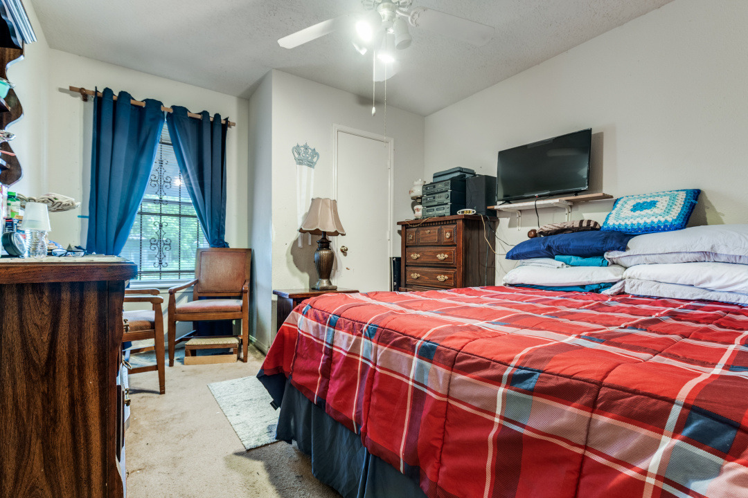 10007 Raymondville Road Houston, TX 77093 - Photo 12 of 19 Bedroom with light carpet and ceiling fan