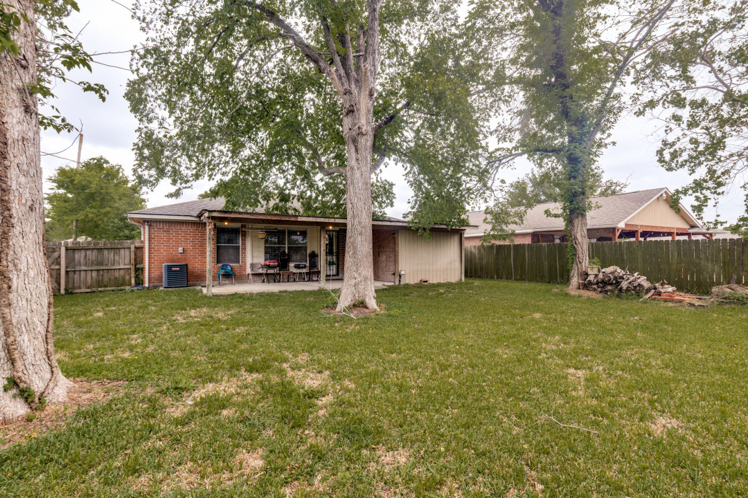 10007 Raymondville Road Houston, TX 77093 - Photo 16 of 19 Back of house with a patio area, a fenced backyard, and brick siding