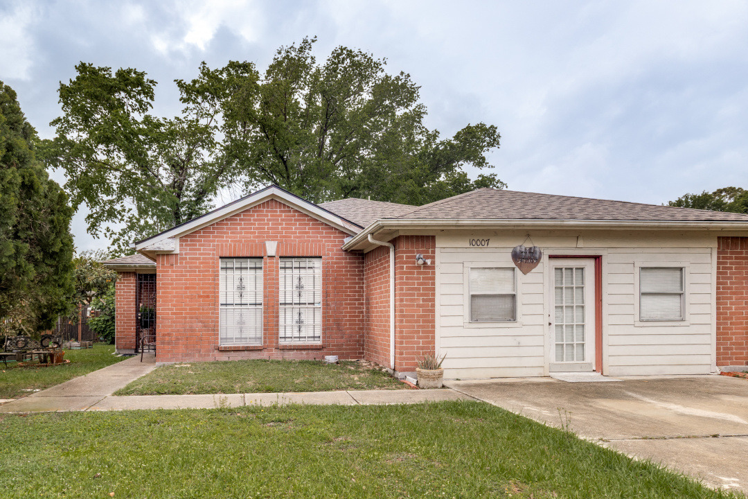 10007 Raymondville Road Houston, TX 77093 - Photo 2 of 19 Ranch-style home with a front lawn, brick siding, and a shingled roof