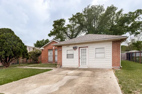front view of a house with a garden