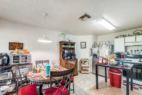 a dining room with furniture and a kitchen view