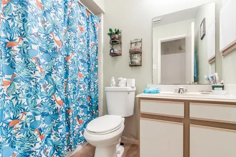a bathroom with a sink toilet and mirror