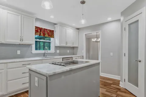 a kitchen with a sink cabinets and window