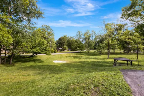 a view of a green field with sitting area