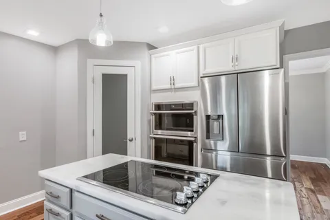a kitchen with a refrigerator sink and microwave