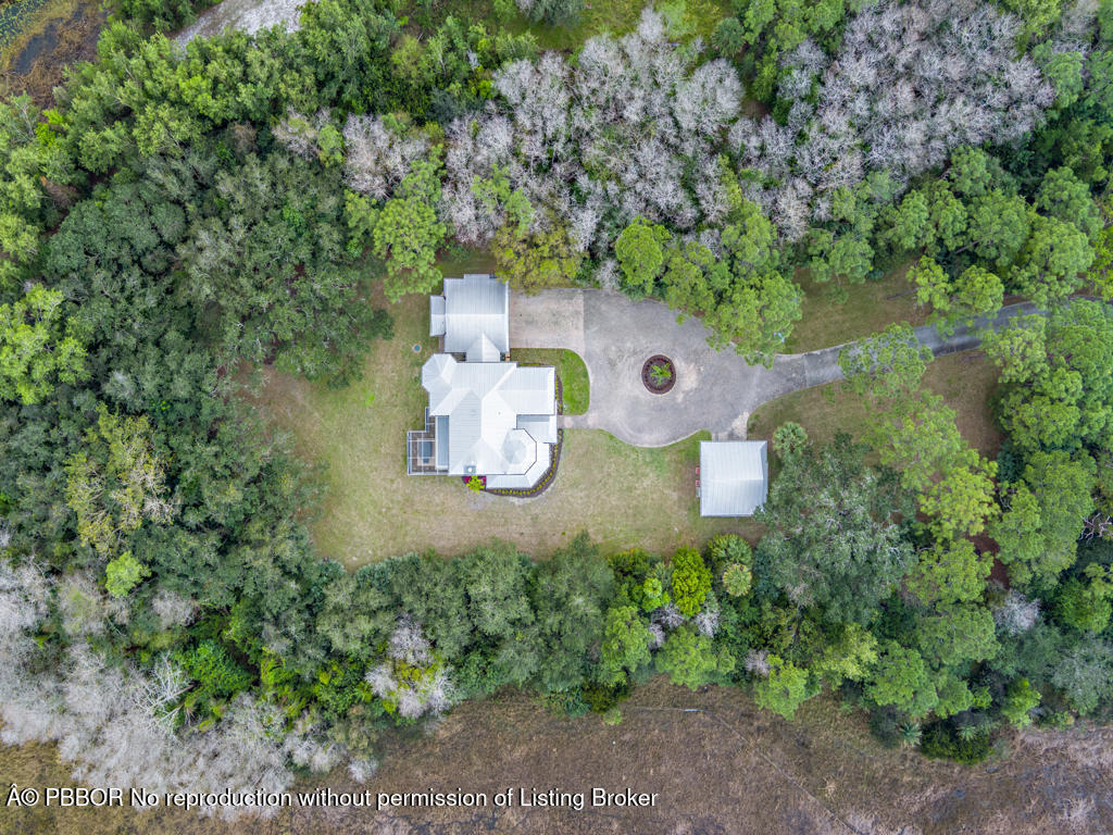1001 Southeast Ranch Road Northeast Jupiter, FL 33478 - Photo 30 of 32 an aerial view of a house with a yard