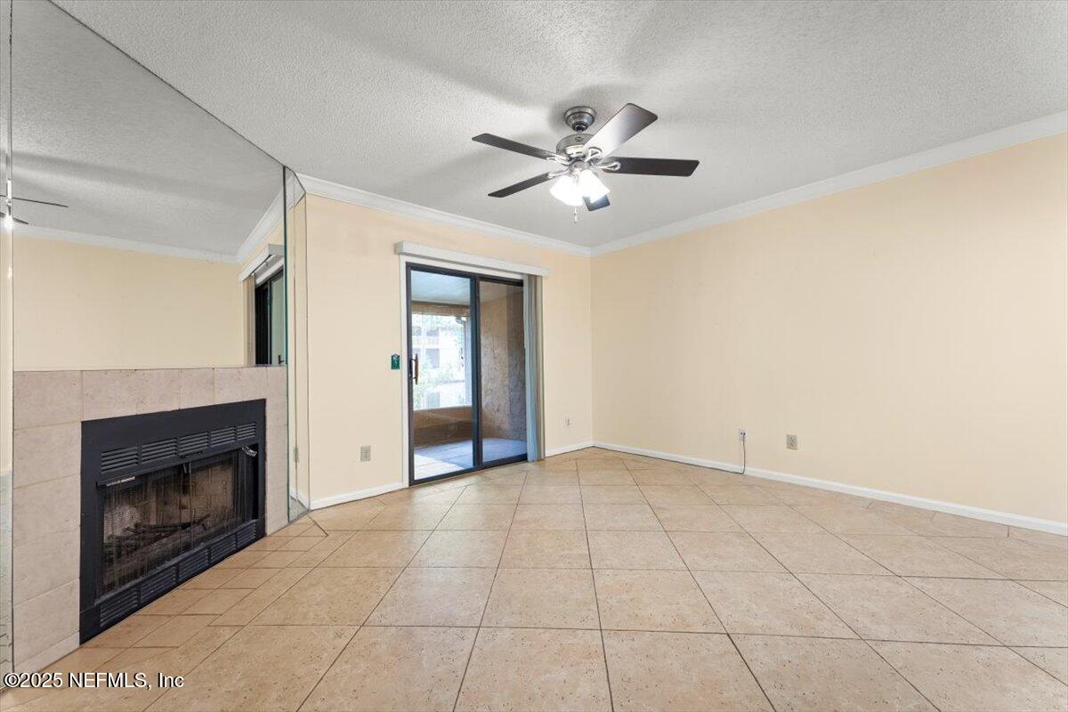 3801 Crown Point Road, Unit 3073 Jacksonville, FL 32257 - Photo 14 of 26 a view of an empty room with chandelier fan and fire place