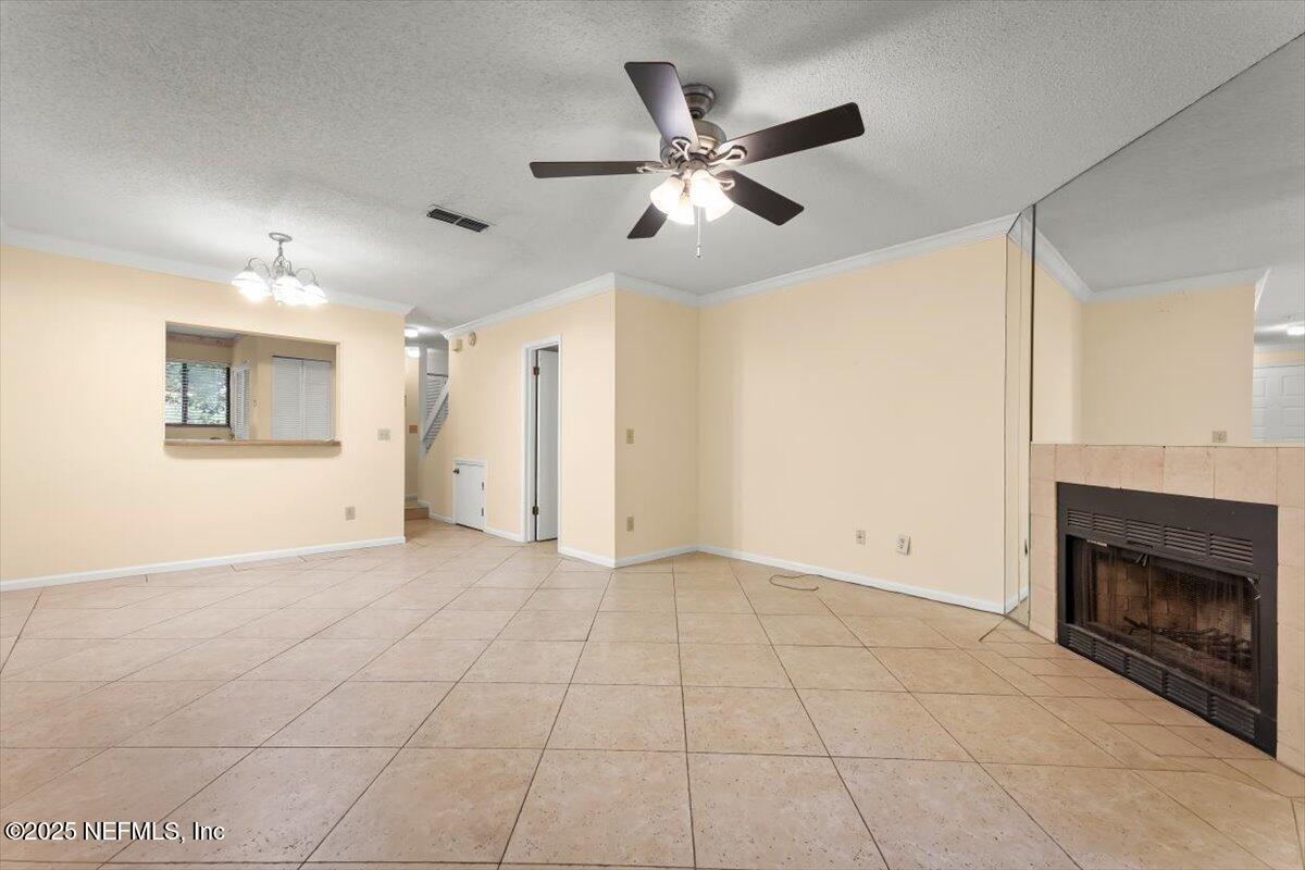 3801 Crown Point Road, Unit 3073 Jacksonville, FL 32257 - Photo 16 of 26 a view of an empty room with chandelier fan and fire place