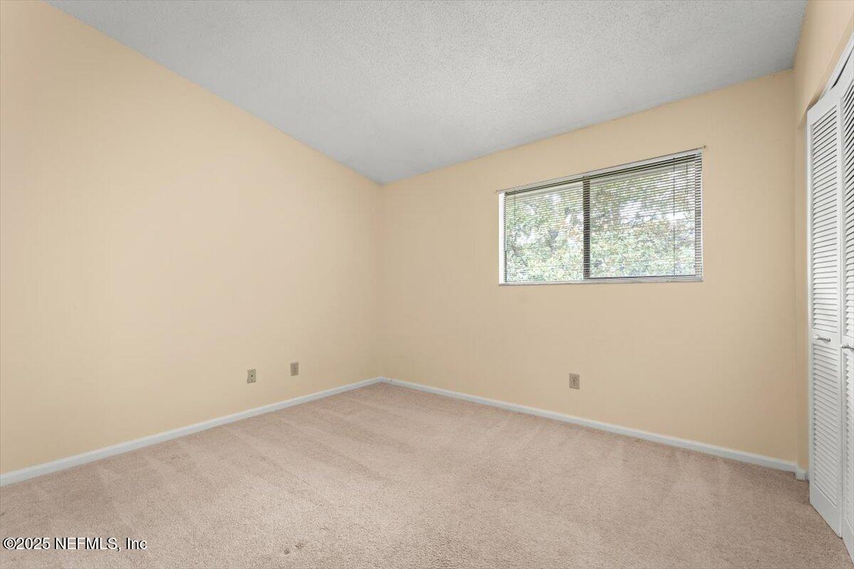 3801 Crown Point Road, Unit 3073 Jacksonville, FL 32257 - Photo 18 of 26 an empty room with windows