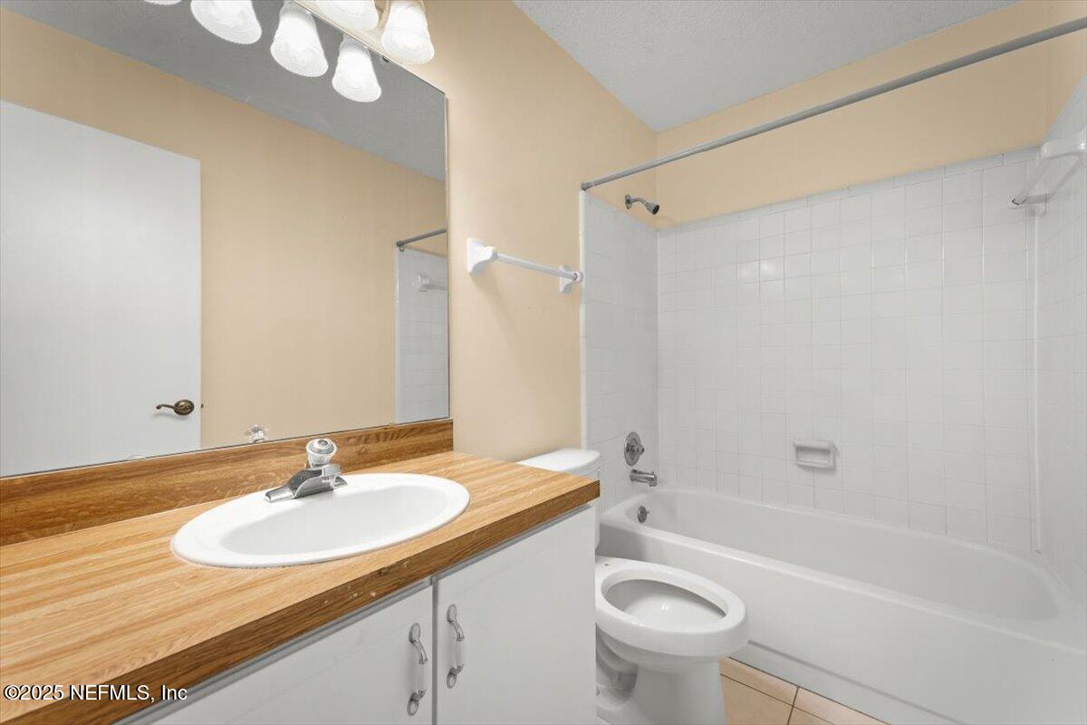 3801 Crown Point Road, Unit 3073 Jacksonville, FL 32257 - Photo 20 of 26 a bathroom with a sink a toilet and a mirror