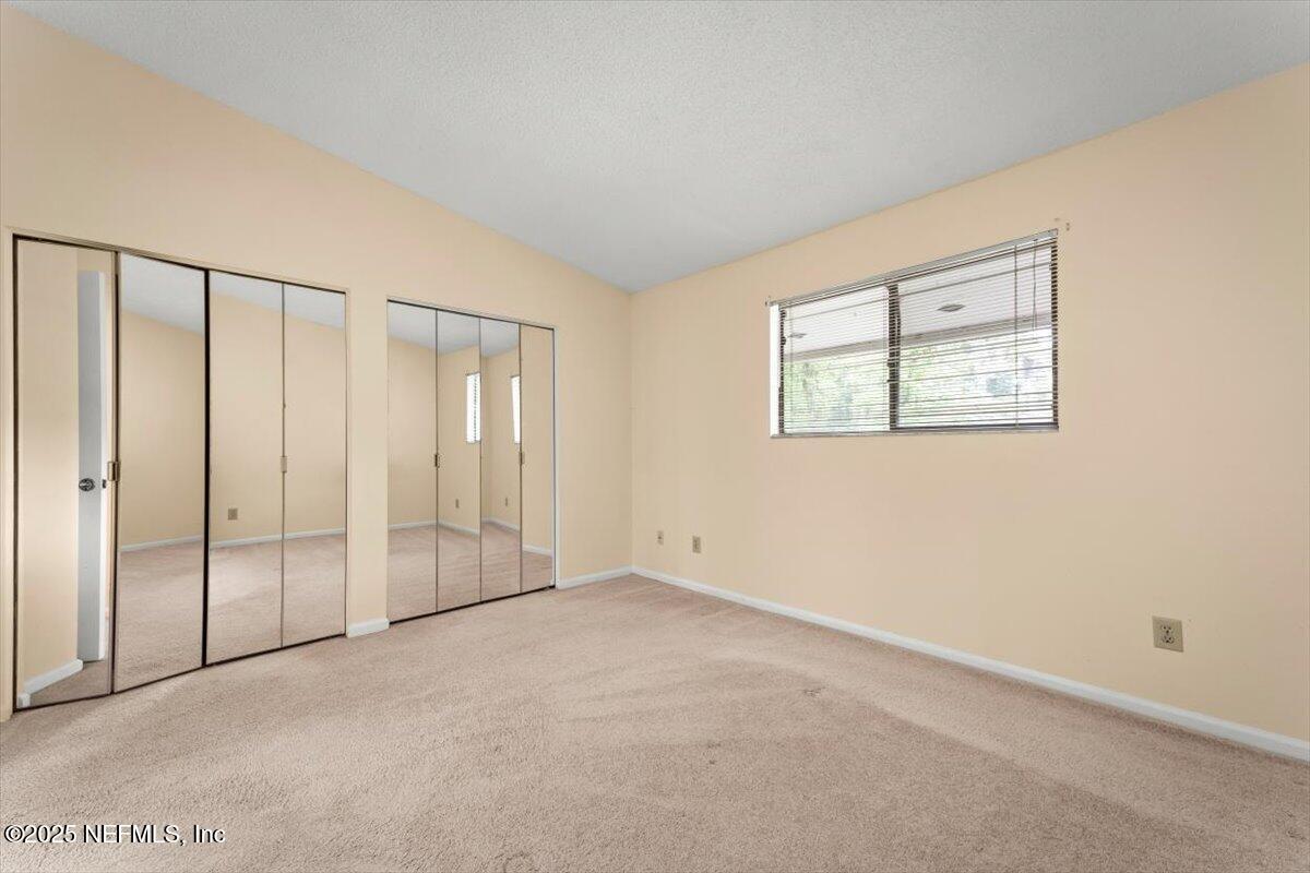 3801 Crown Point Road, Unit 3073 Jacksonville, FL 32257 - Photo 22 of 26 an empty room with windows and closet